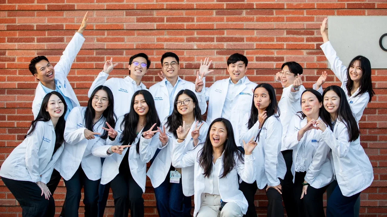 APAMSA group members in front of brick wall